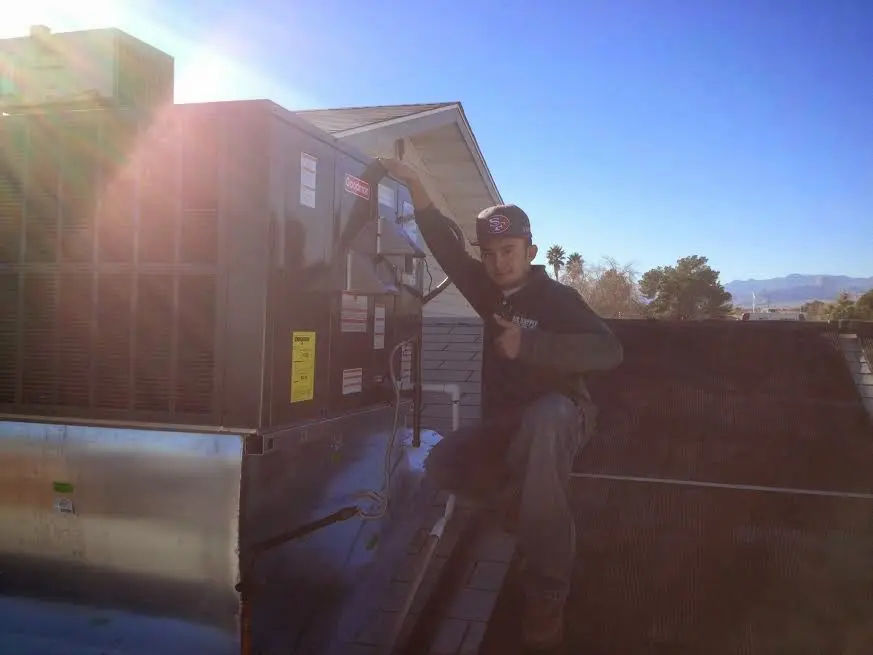 HVAC technician performing Heat Pump Repair on a rooftop unit in Union